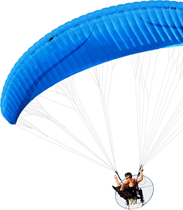 Paramotor pilot flying under a blue wing