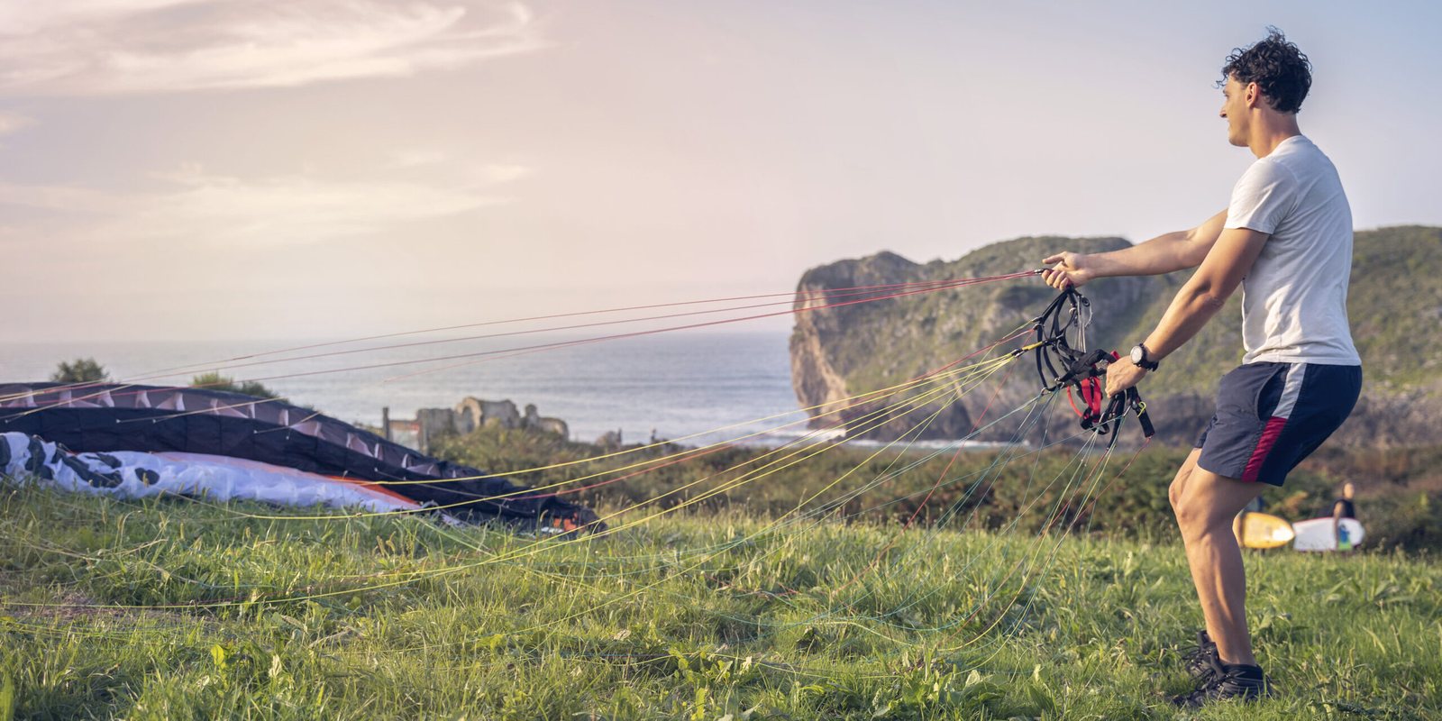 A man preparing a paramotor wing for kiting.