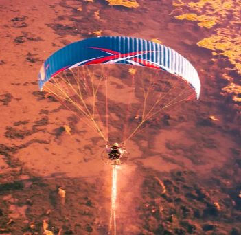 Aerial view of a paramotor pilot in flight using ITV paramotor wings.