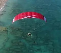 Aerial view of a paramotor pilot in flight using ITV Piper Tandem paramotor wings.