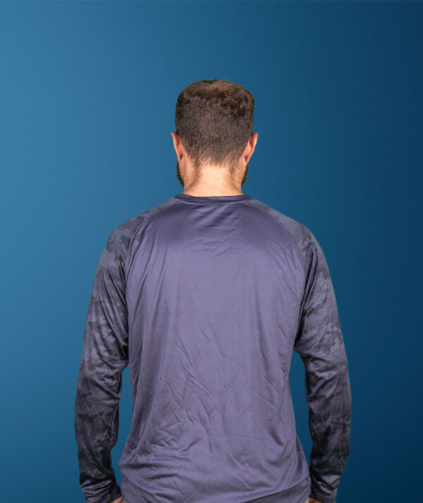 Back view of a man wearing a dark gray Lonestar Paramotor long-sleeve shirt.