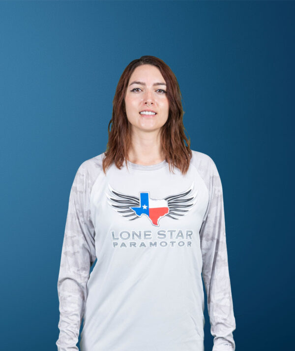 Front view of a woman wearing a light gray Lonestar Paramotor long-sleeve shirt.