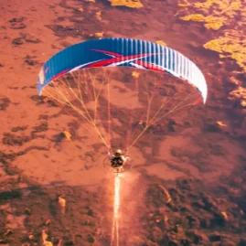 Aerial view of a paramotor pilot in flight using ITV paramotor wings.