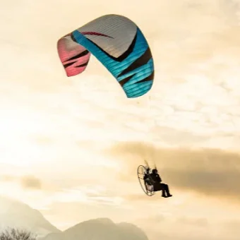 Aerial view of a paramotor pilot in flight using ITV paramotor wings.