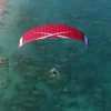 Aerial view of a paramotor pilot in flight using ITV Piper Tandem paramotor wings.