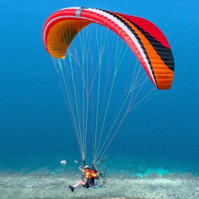 Aerial image of a paramotor pilot flying with MAC PARA Charger 2 wings.