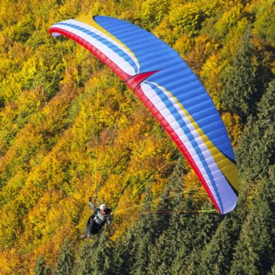 Aerial image of a paramotor pilot flying with MAC Para Illusion 2 Hybrid EN-B wings.