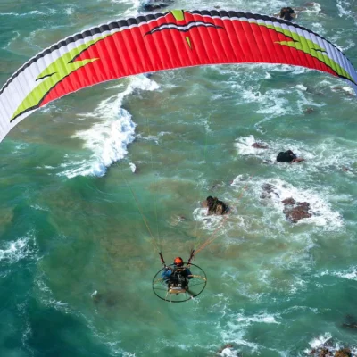 Aerial image of a paramotor pilot flying with MAC Para Samurai wings.