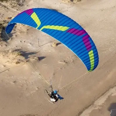Aerial image of Ozone Kona 3 paramotor wing in flight