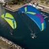 Aerial image of a pair of Ozone Kona 3 paramotor wings in flight