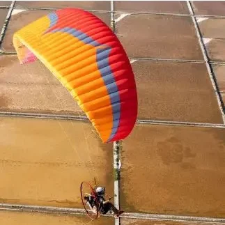 Aerial shot of a Ozone Mojo PWR 2 paramotor wing in flight.