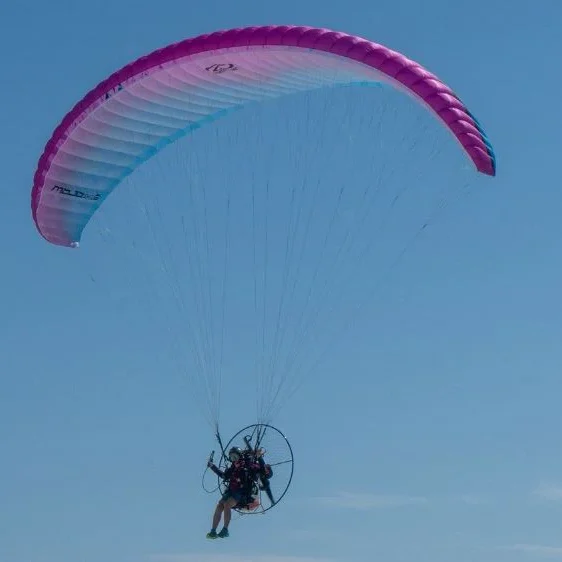 Aerial shot of a Ozone Mojo PWR 2 paramotor wing in flight.