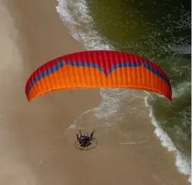 Aerial shot of a Ozone Mojo PWR 2 paramotor wing in flight.