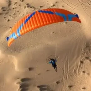 Aerial view of Ozone MoxiePWR paramotor wing in flight.