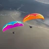 A pair of Ozone Roadster 3 paramotor wings in flight.