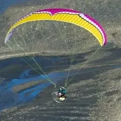 Aerial image of an Ozone Sypder 3 paramotor wing in flight.