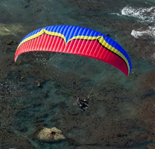 Aerial image of an Ozone Sypder 3 paramotor wing in flight.